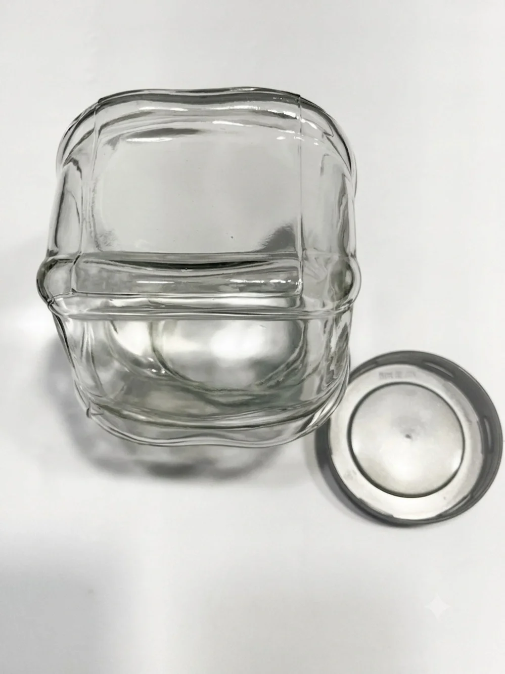Ikea Förvar glass canister featuring a distinctive hexagonal shape & a gray lid.
